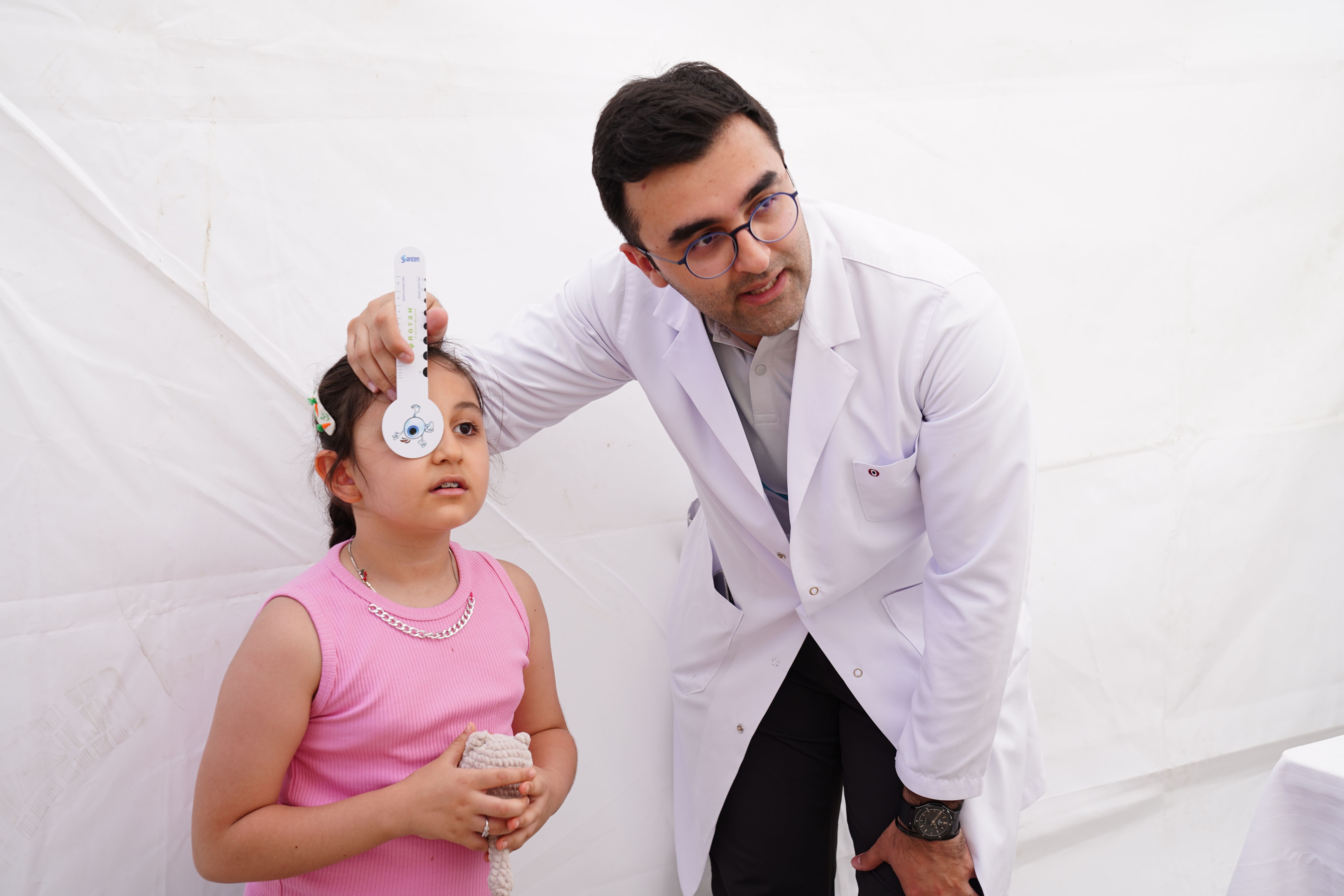 Child undergoing an eye checkup at an eye hospital in Hyderabad with an ophthalmologist performing a vision examination.